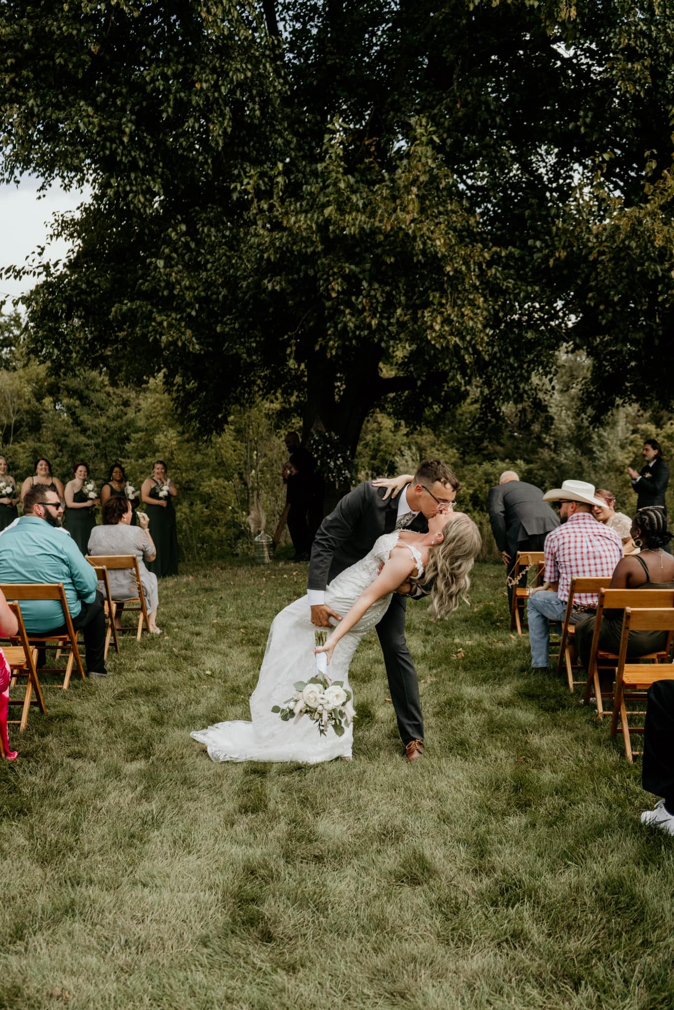bride and groom kissing in aisle
