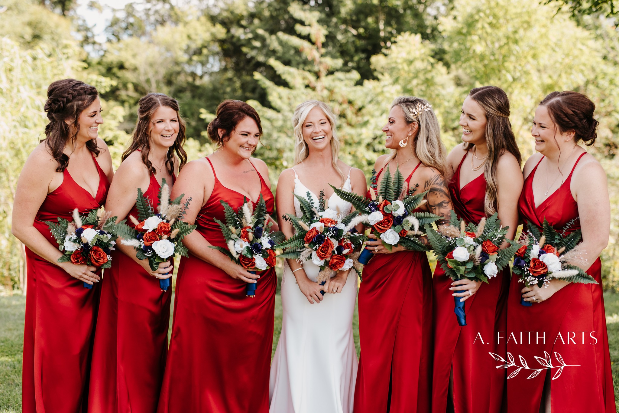 bride with bridesmaids in red gowns