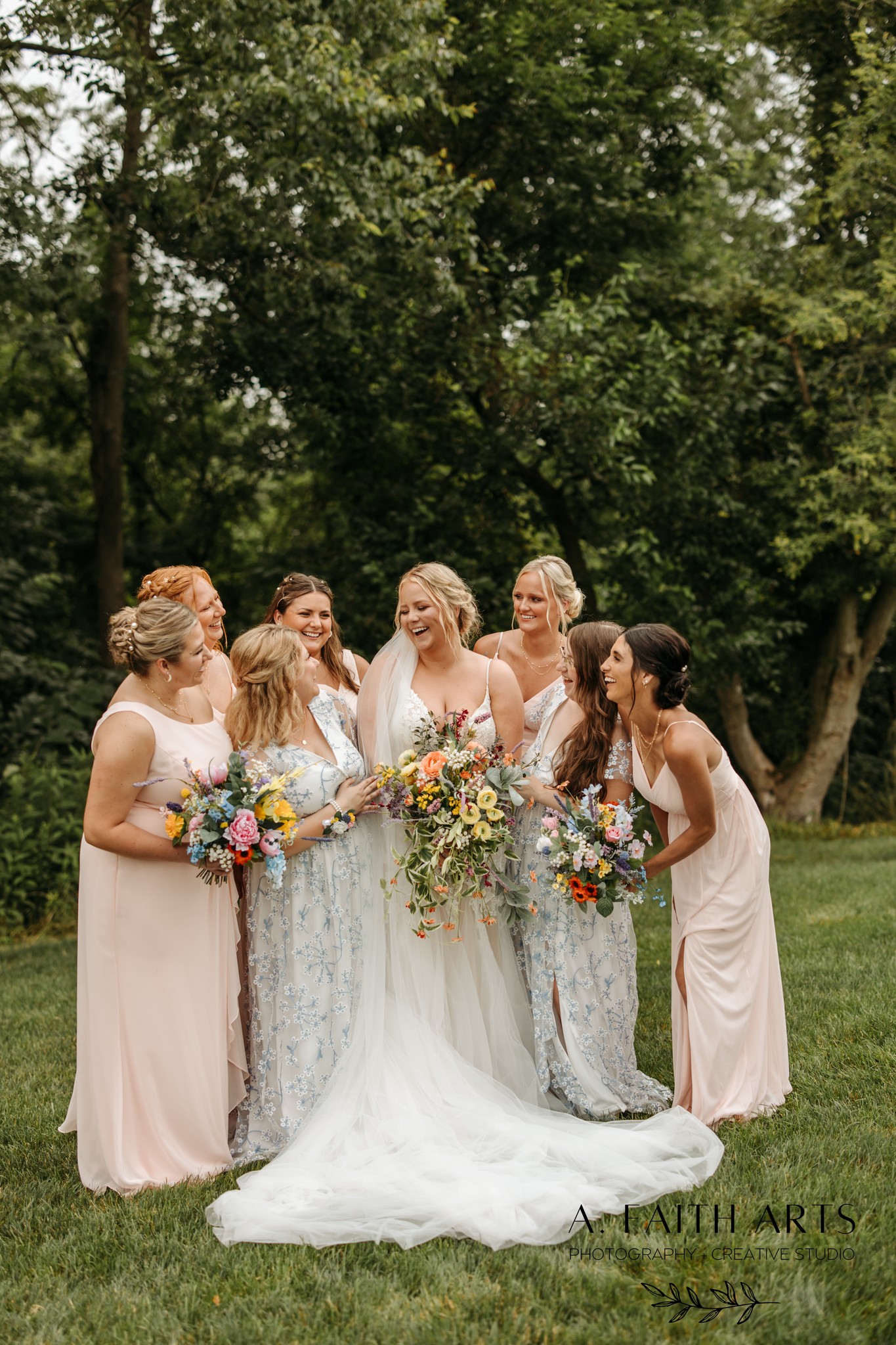 summer bride laughing with bridesmaids