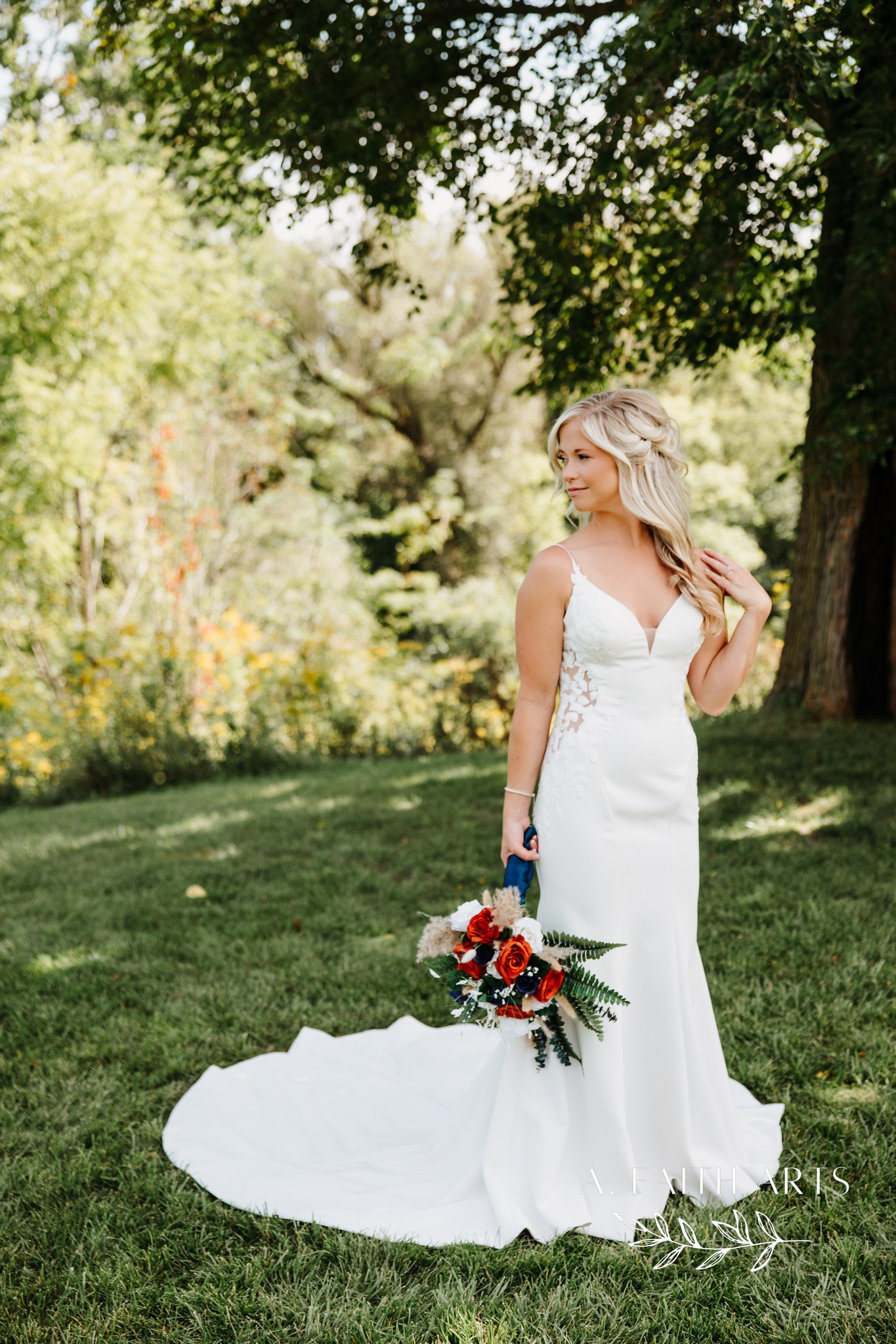 bride posing in green field