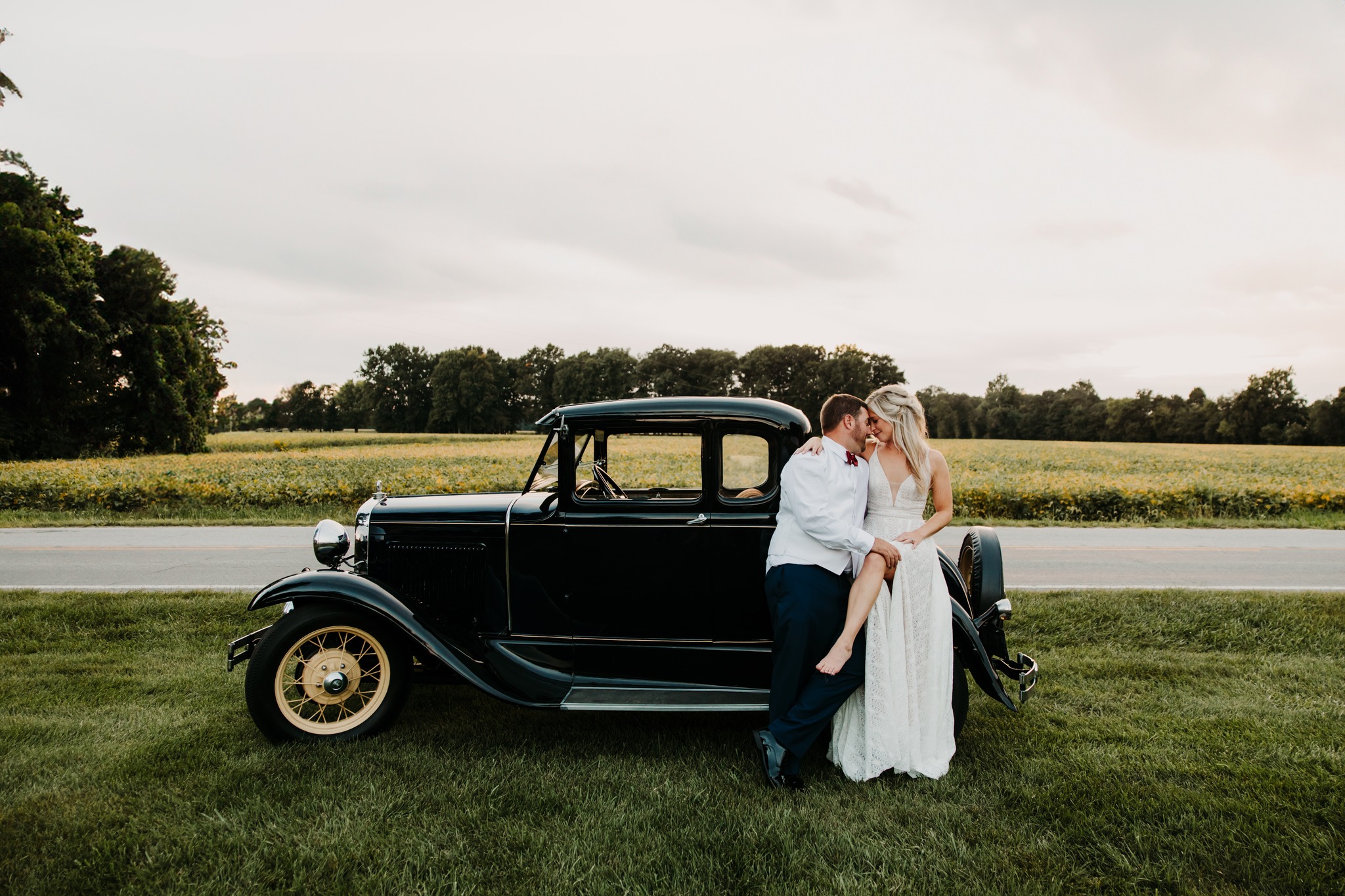 bride and groom with vintage car