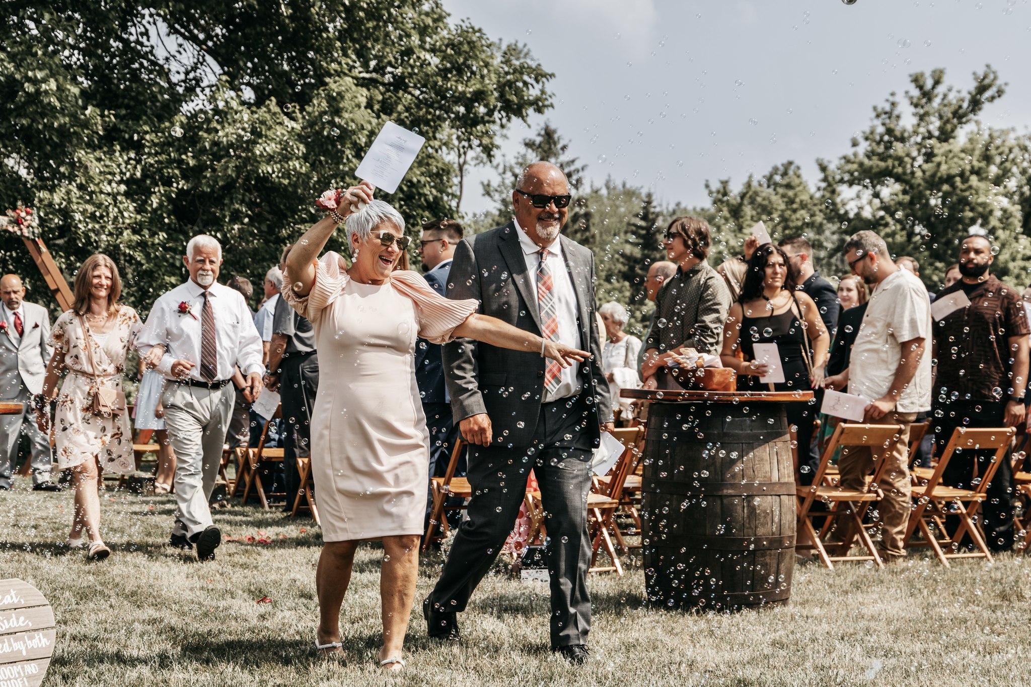 wedding guests cheering and blowing bubbles