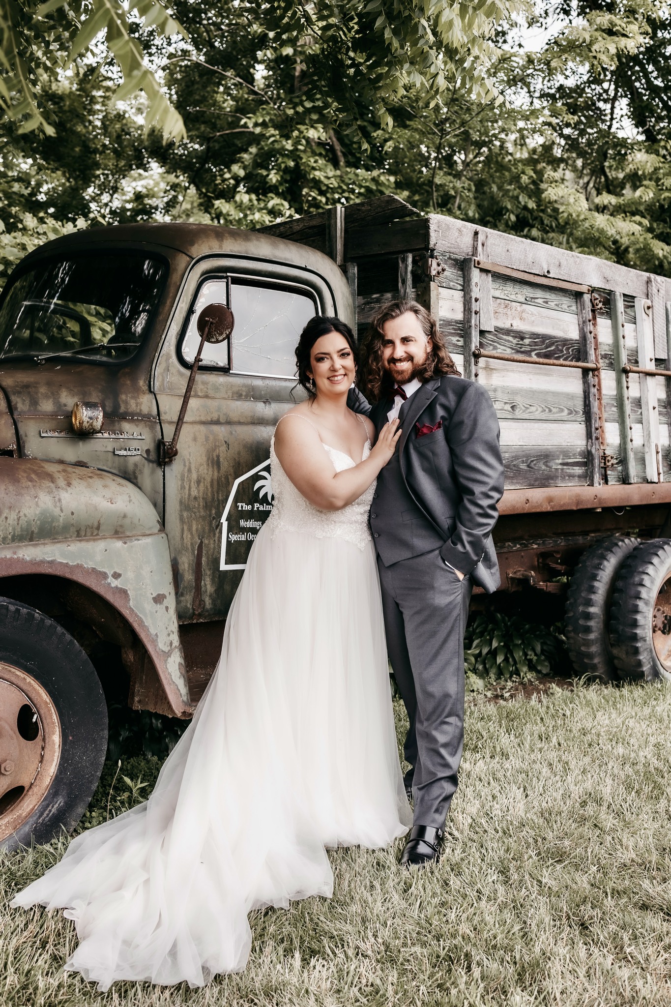 bride and groom in front of vintage truck