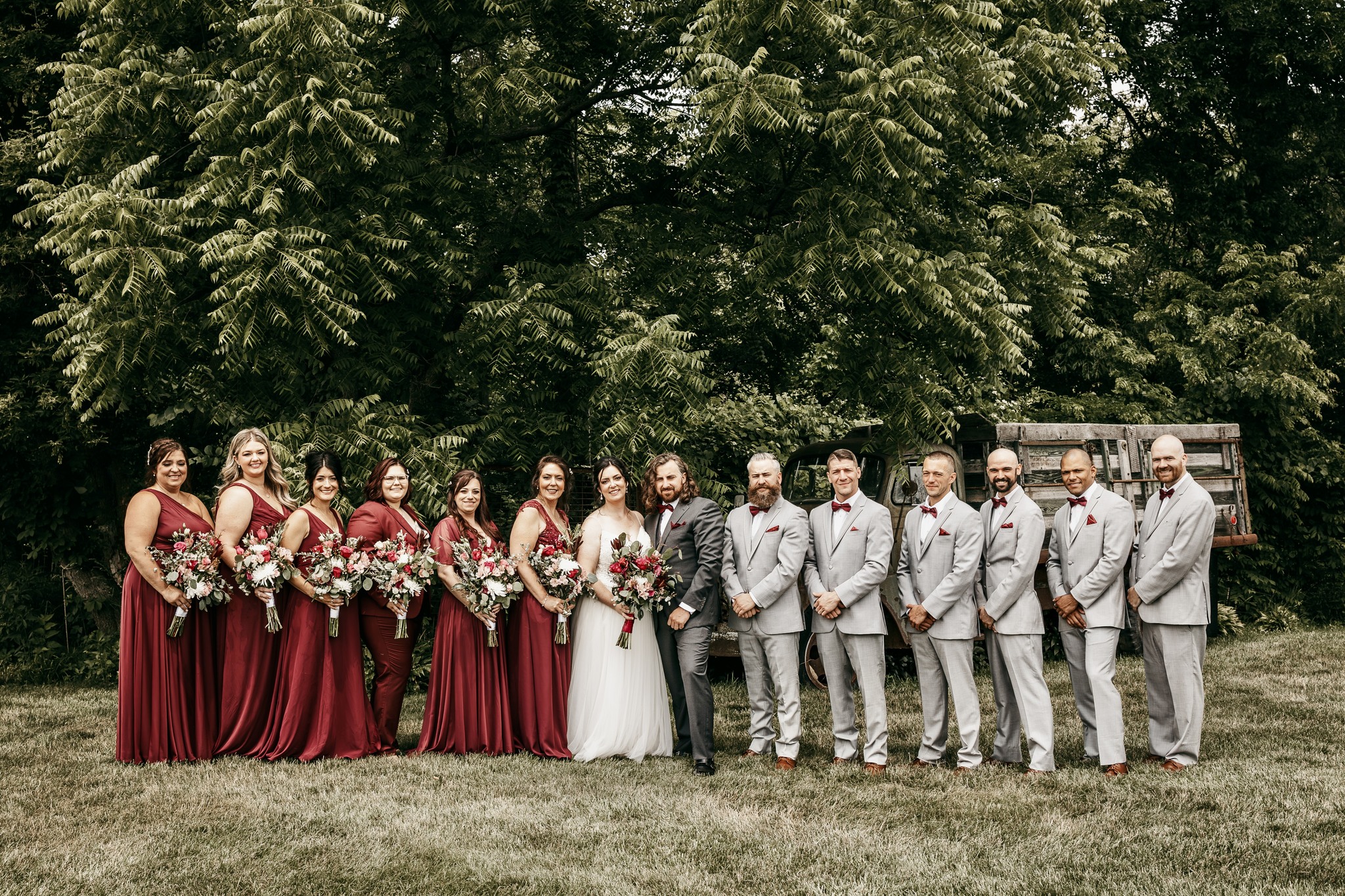 bride and groom outdoors with wedding party
