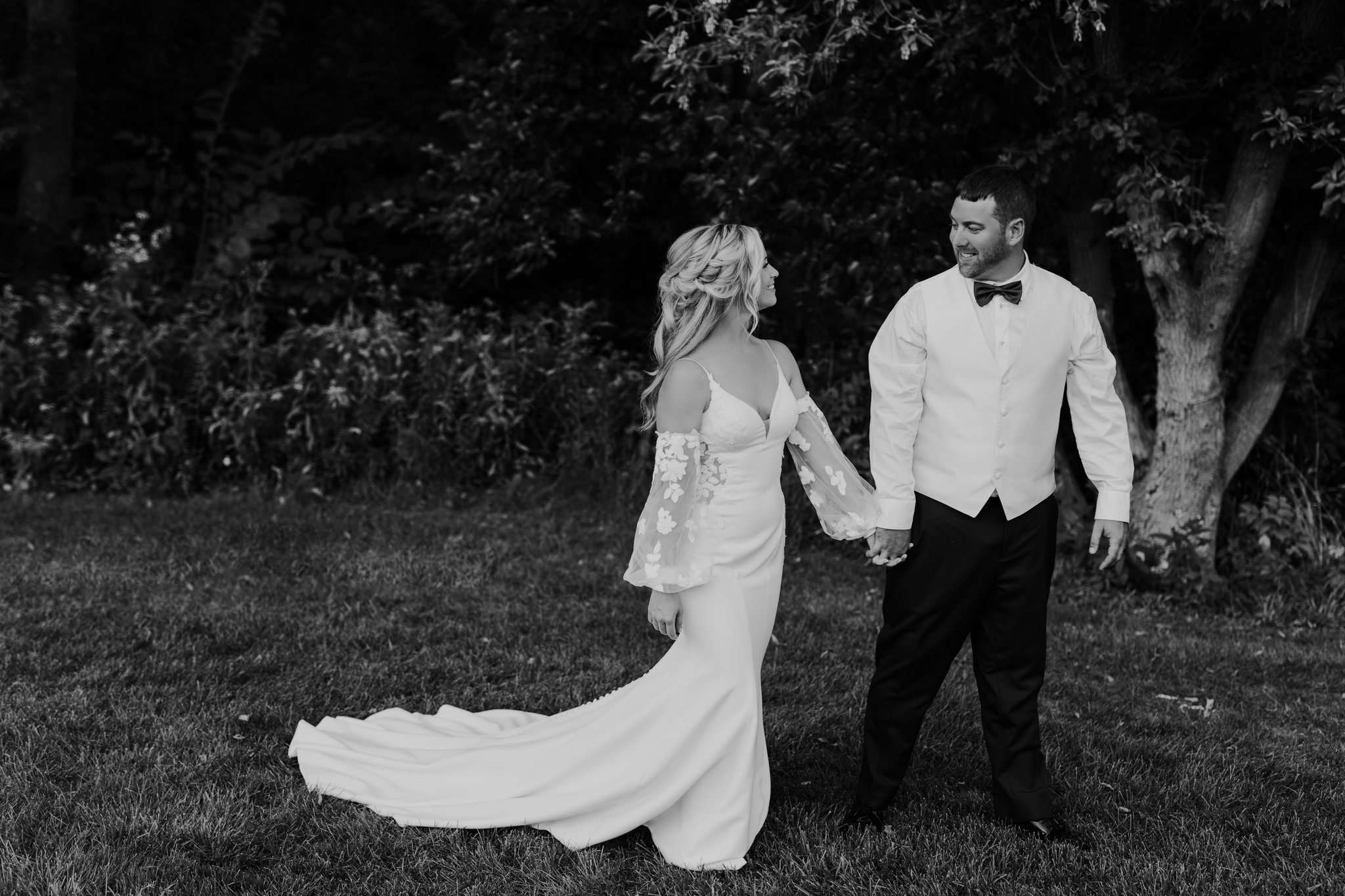 bride and groom holding hands at outdoor wedding ceremony
