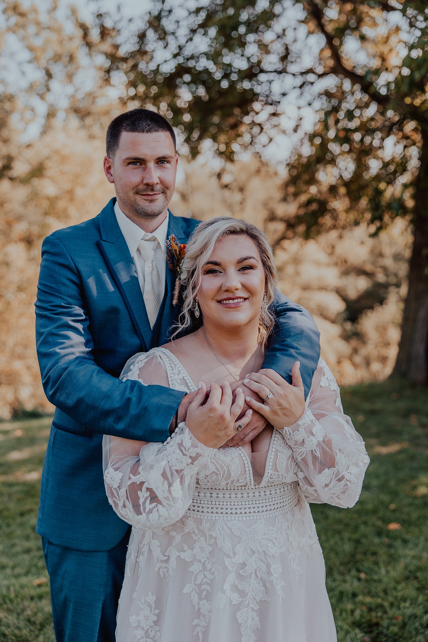 groom embracing bride