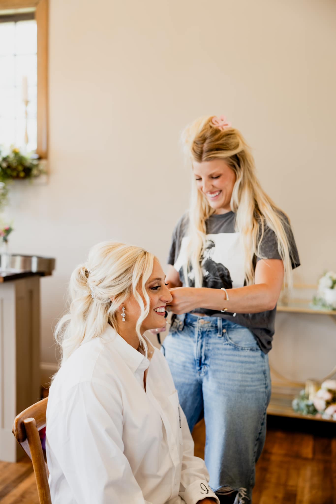 hairstylist curling bride's hair