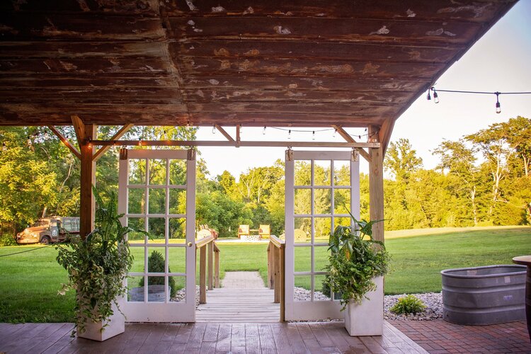 antique doors leading to open air venue at the palm tree barn
