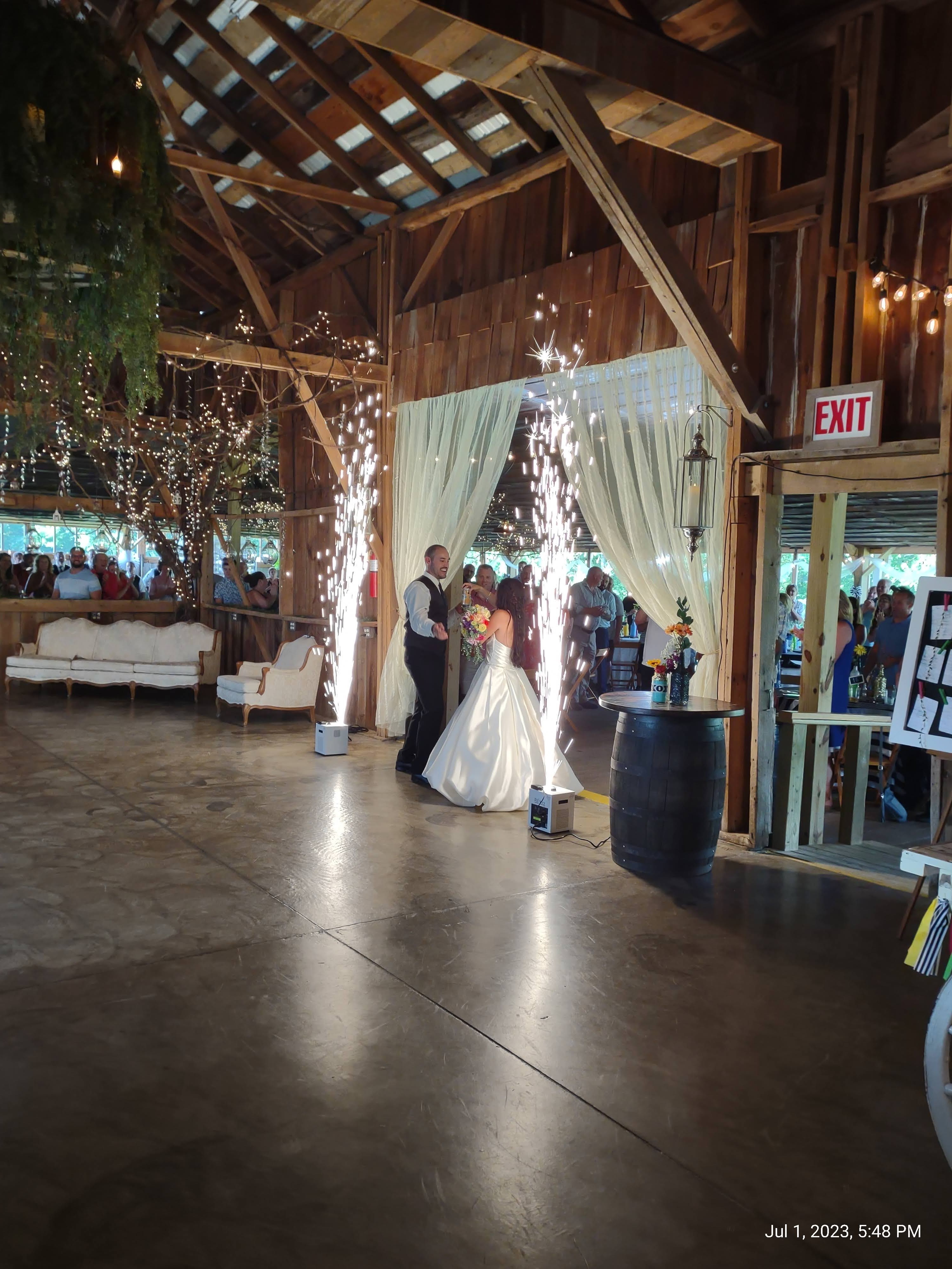 bride and groom entering wedding reception with sparklers